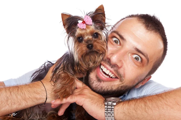 stock image Young man holding a cute yorkie puppy dog