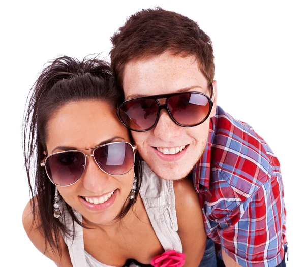 Young couple wearing sunglasses and smiling at you — Stock Photo, Image