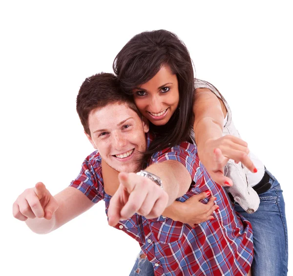 Young woman riding on her boyfriend's back and pointing — Stock Photo, Image