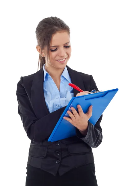 Young business woman writing on a clipboard — Stock Photo, Image