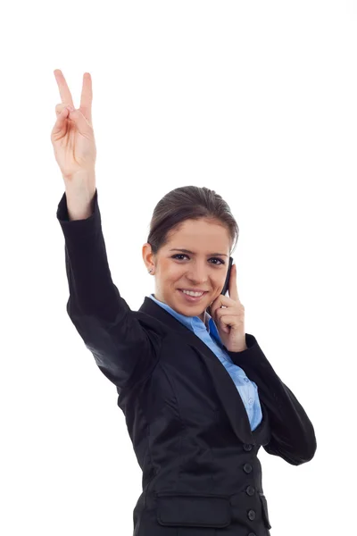 Young business woman showing victory sign and speaking at phone — Stock Photo, Image