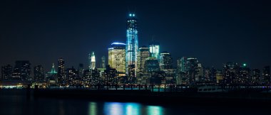 Lower Manhattan from Hudson river at night clipart