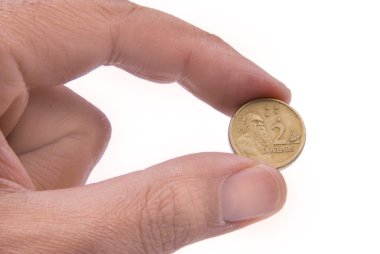 Australian coin held by two fingers clipart