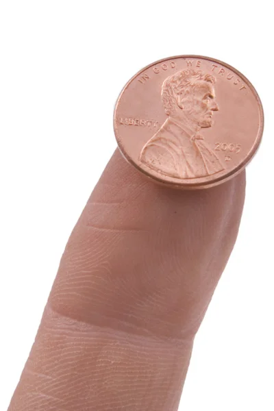 Penny equilibrado em um dedo — Fotografia de Stock