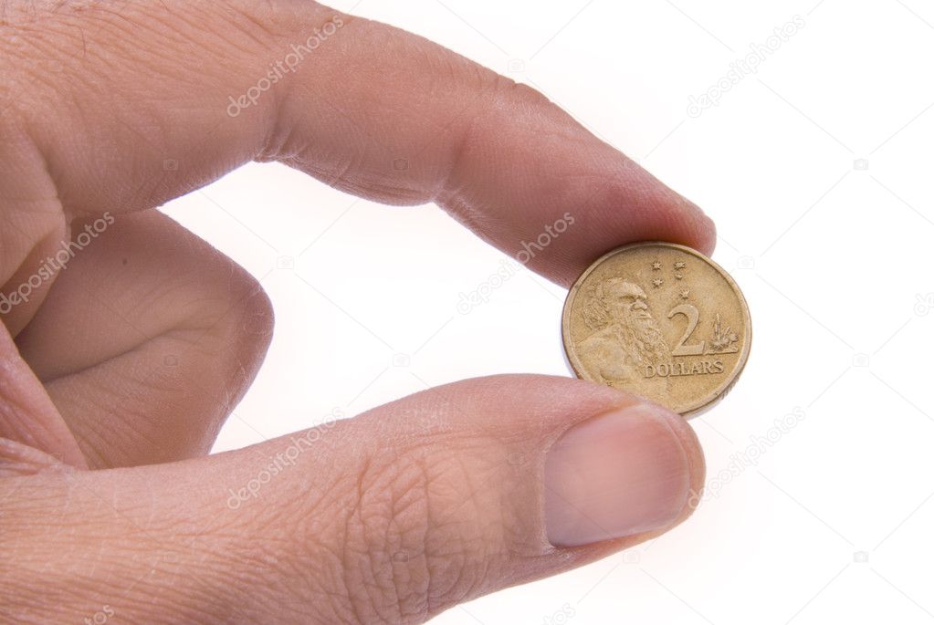 Australian coin held by two fingers