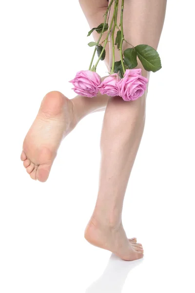 Female legs with flowes over white background — Stock Photo, Image