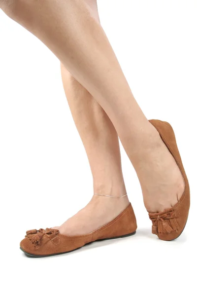 stock image Woman legs with brown shoes over white