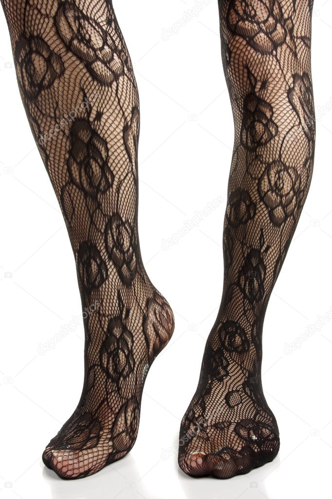 Female legs wearing floral leggings and heels over white backgro