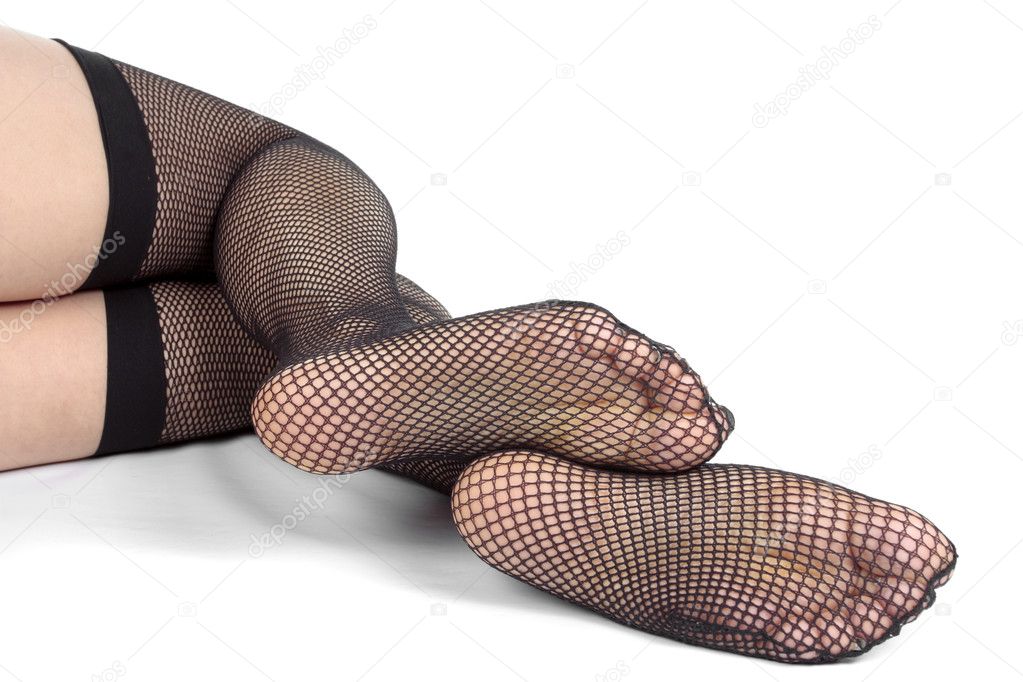 Woman legs wearing black lace tights over white background