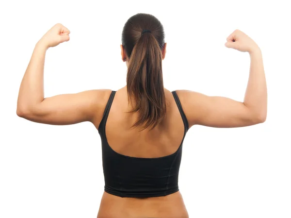 Mujer joven fuerte y musculosa mostrando sus músculos aislados en blanco — Foto de Stock