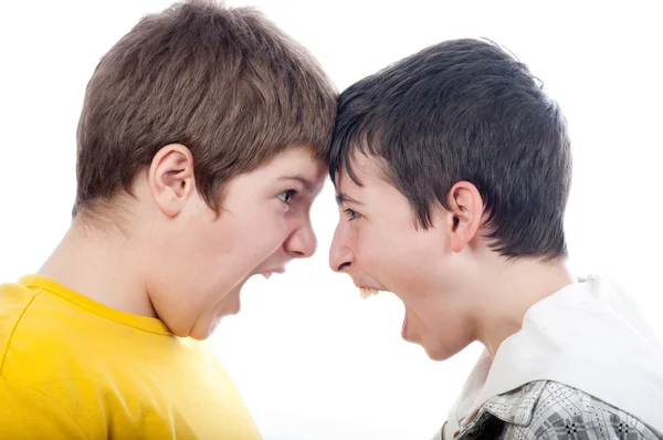 Two teenage boys screaming at each other isolated on white — Stock Photo, Image