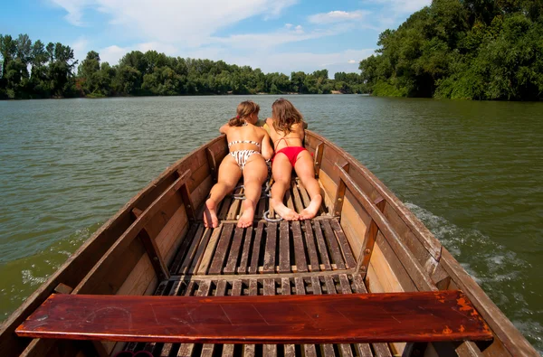 Cute teenage girls sunbathing in the boat on sunny summer day — Stock Photo, Image