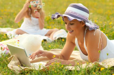 Mother and daughter having fun in the nature on sunny summer day clipart