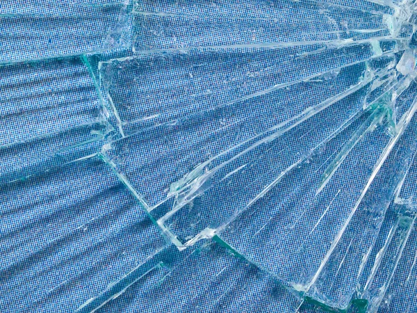 stock image Cracked Glass Macro with a Sky Blue Patterned Background