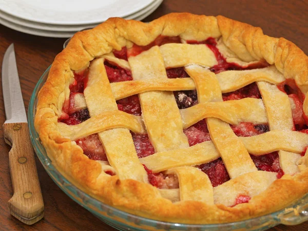 stock image Fresh Baked Three-Berry Pie with Lattice Crust with Plates and Knife