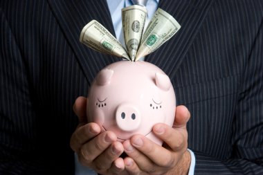 Businessman Holding Piggy Bank clipart