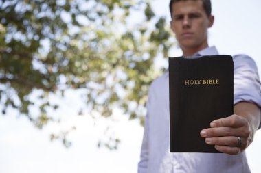 Man Holds Bible clipart