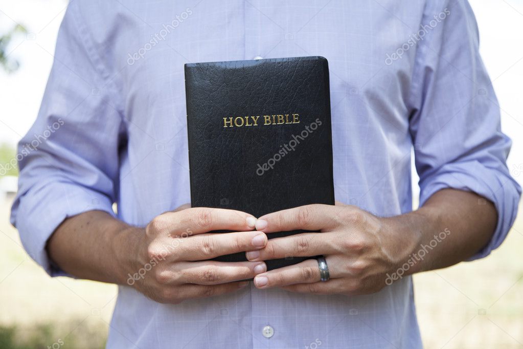 Man Holding Black Bible