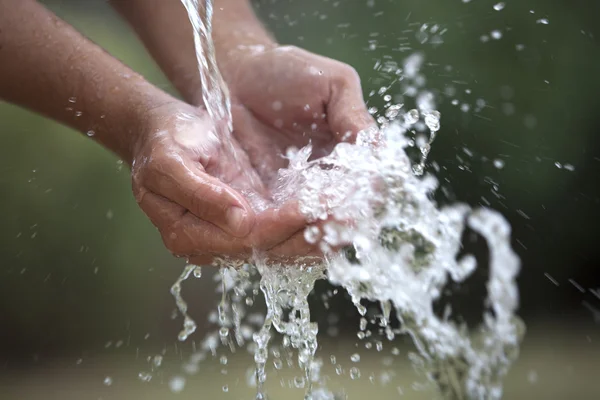 Przelewanie wody w ręce — Zdjęcie stockowe