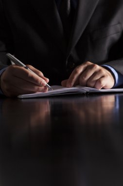 Businessman Writes in Notebook clipart