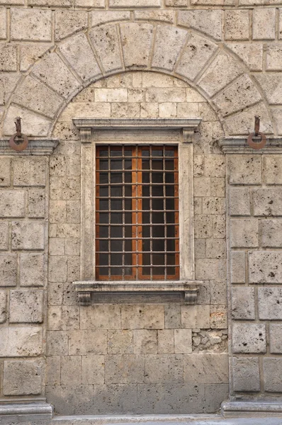 Gitter in einem Fenster in Steinmauer — Stockfoto