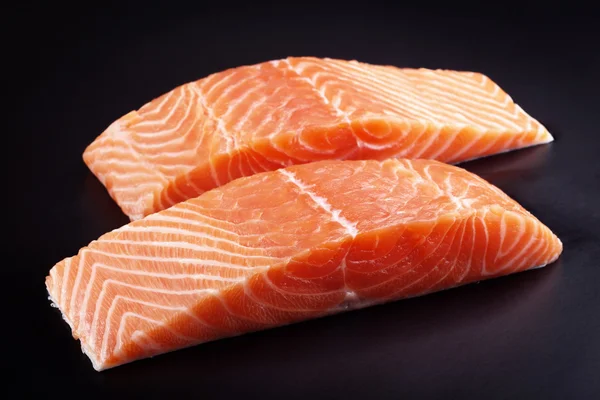 Piece of raw fresh salmon isolated on black background — Stock Photo, Image