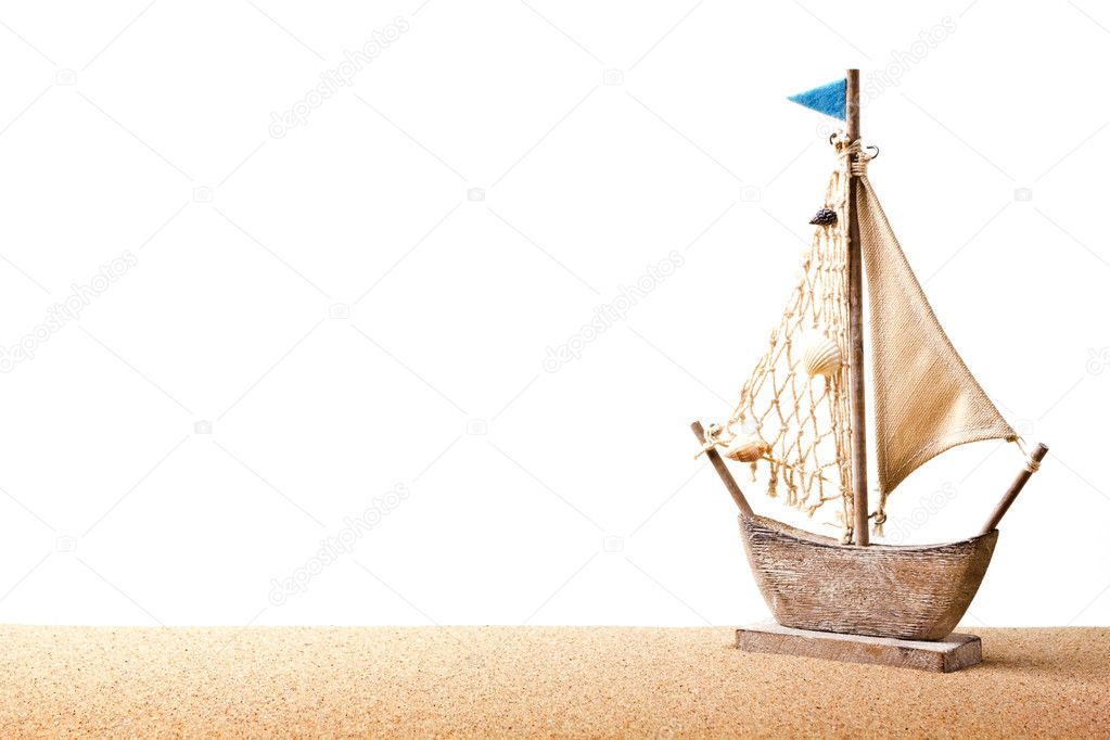 Ship toy model in the sand on the beach