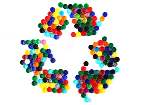 Symbol recyceln aus farbigen Kunststoffkappen — Stockfoto