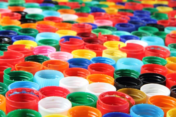 Цвет пластмассовые шапки фон — стоковое фото