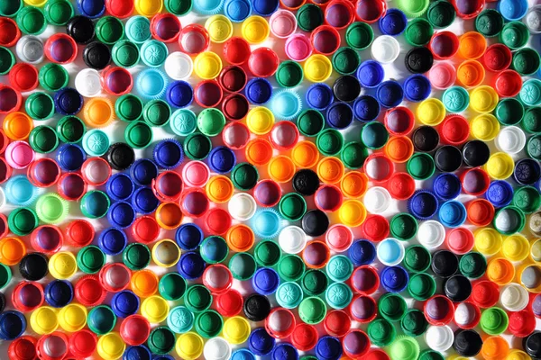 Color plastic caps background — Stock Photo, Image
