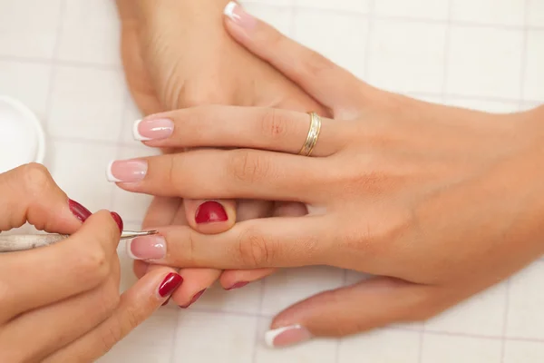 Pair of mature hands having the nails filed — Stock Photo, Image