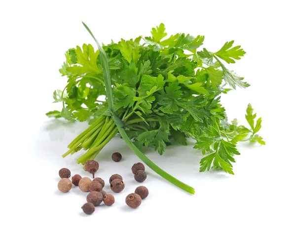 Bunch of fresh green parsley with grains of pepper on white background — Stock Photo, Image