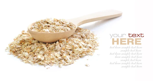 Oat flakes in wooden spoon on white background — Stock Photo, Image
