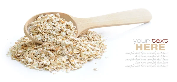 Oat flakes in wooden spoon on white background — Stock Photo, Image