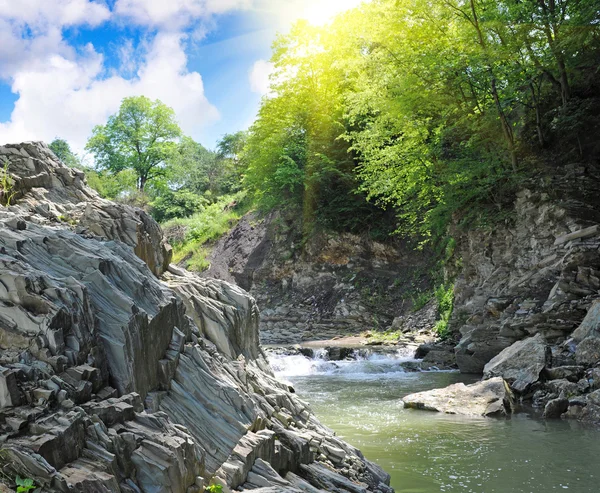 Tranquil waterfall with rocks by a summer — Stock Photo, Image
