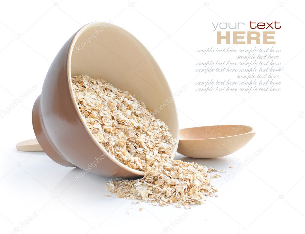 Oat flakes in bowl and wooden spoon on white background