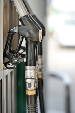 Pump nozzles at the gas station. Shallow depth of field with foc clipart