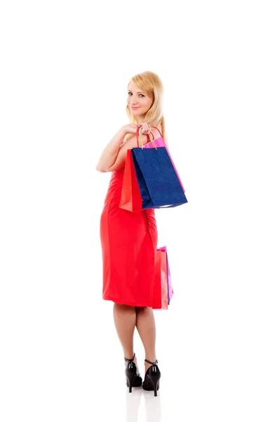 Vrouw die lacht bedrijf shopping tassen — Stockfoto