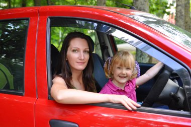 Mother and daughter in a car clipart