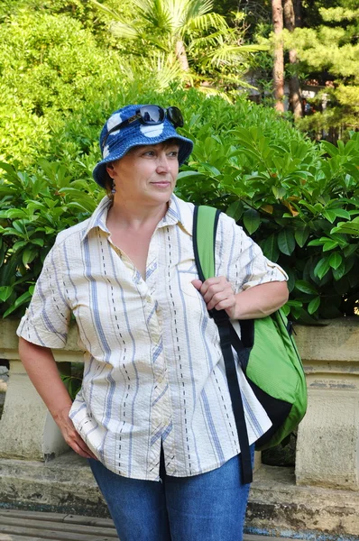 Middle-aged female tourist with a backpack — Stock Photo, Image
