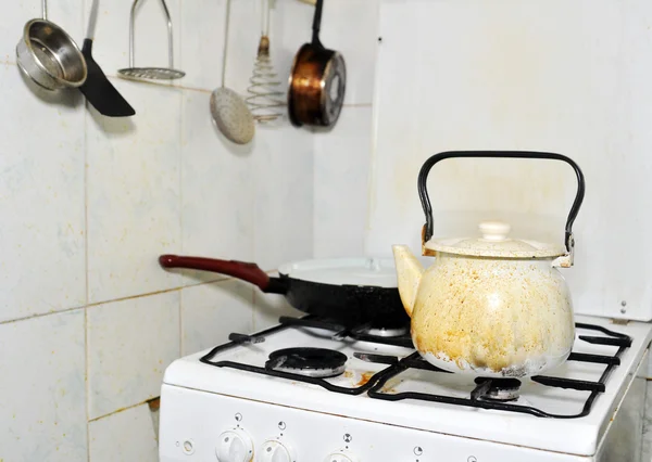 stock image Dirty gas stove with a kettle and a frying pan