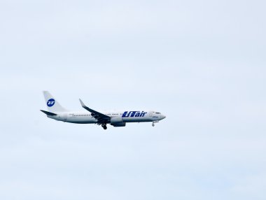 Airplane of UTair company flying clipart