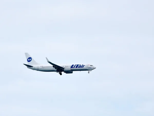 Airplane of UTair company flying — Stock Photo, Image