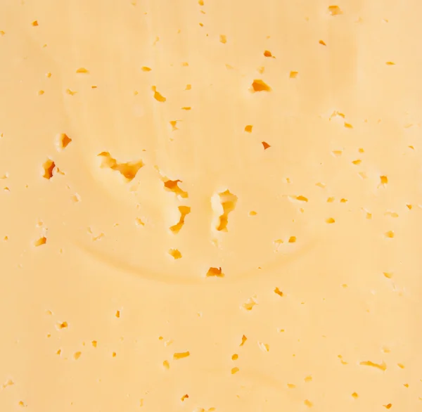 Fondo de queso suizo amarillo fresco con agujeros — Foto de Stock