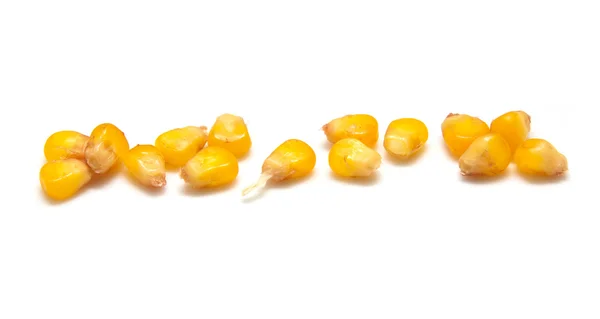 白い背景の上の黄色いトウモロコシ粒 — ストック写真