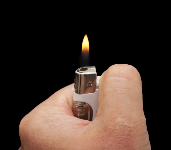 stock image Hand with a cigarette lighter on a black background