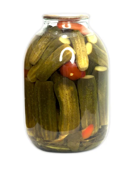 In a glass jar marinaded cucumbers and tomatoes on a white backg — Stock Photo, Image