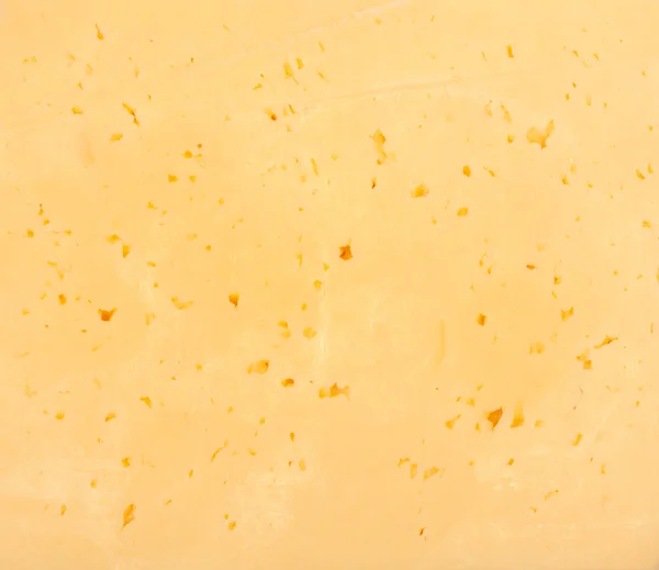 Фон из свежего желтого швейцарского сыра с отверстиями — стоковое фото