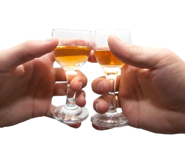 Duas mãos com copos de vinho em branco isolado — Fotografia de Stock