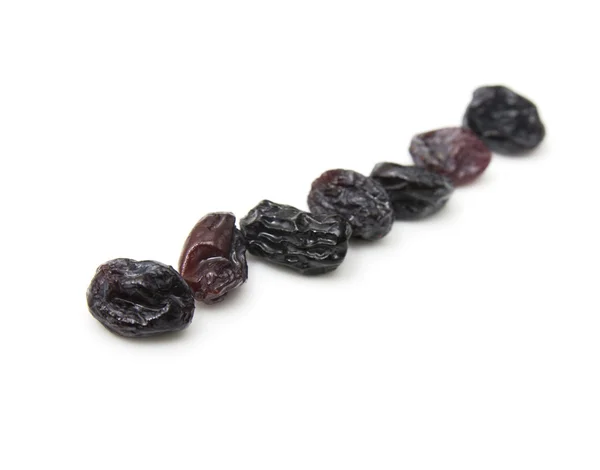 Black raisins set on white background. — Stock Photo, Image